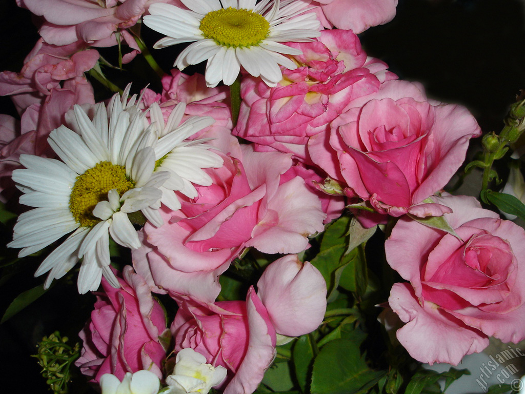 A bouquet consisting of rose, daisy and snapdragon flowers.
